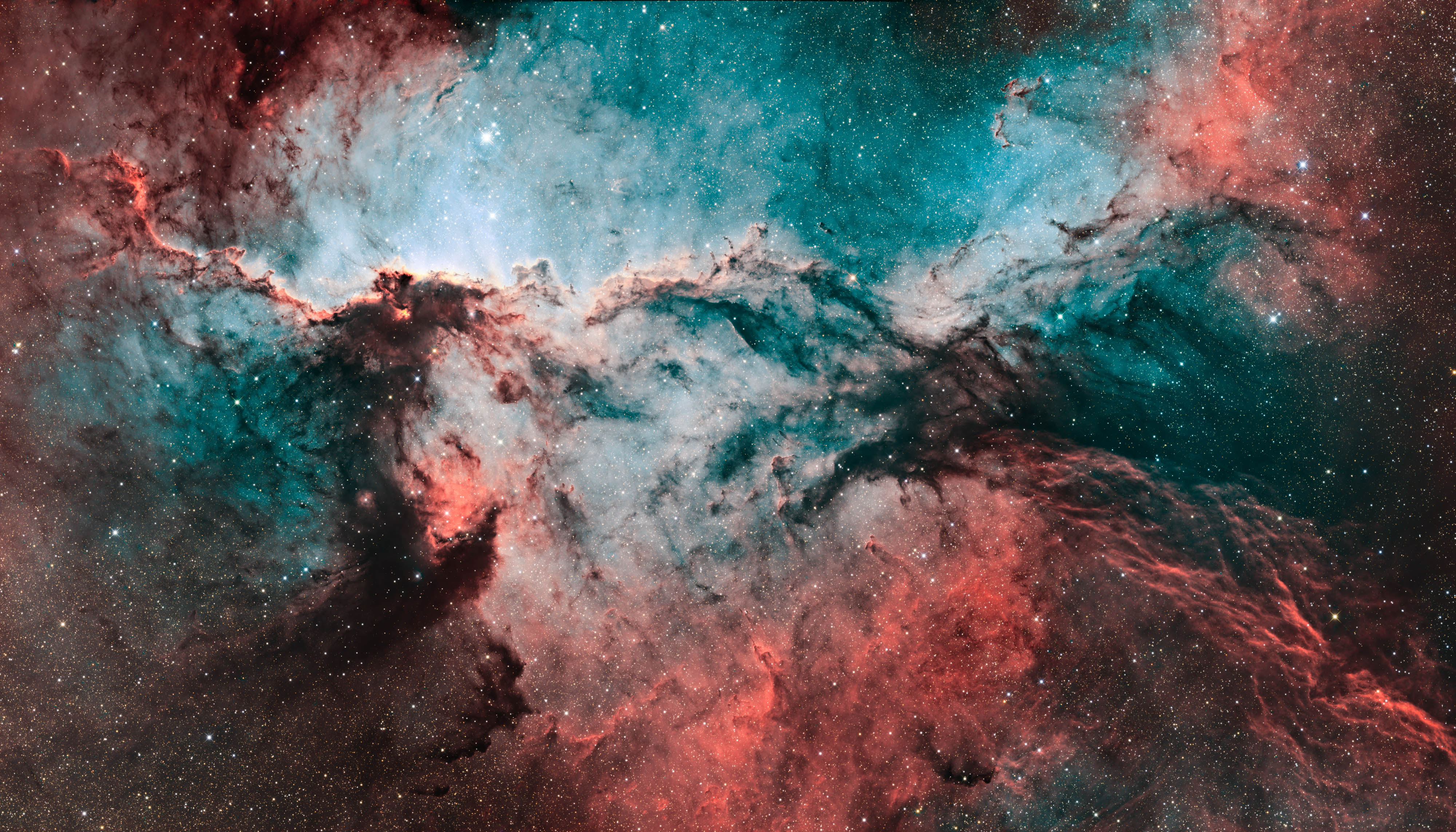 Jens Unger’s photograph of NGC 6188, with teal and red nebula clouds surrounded by stars